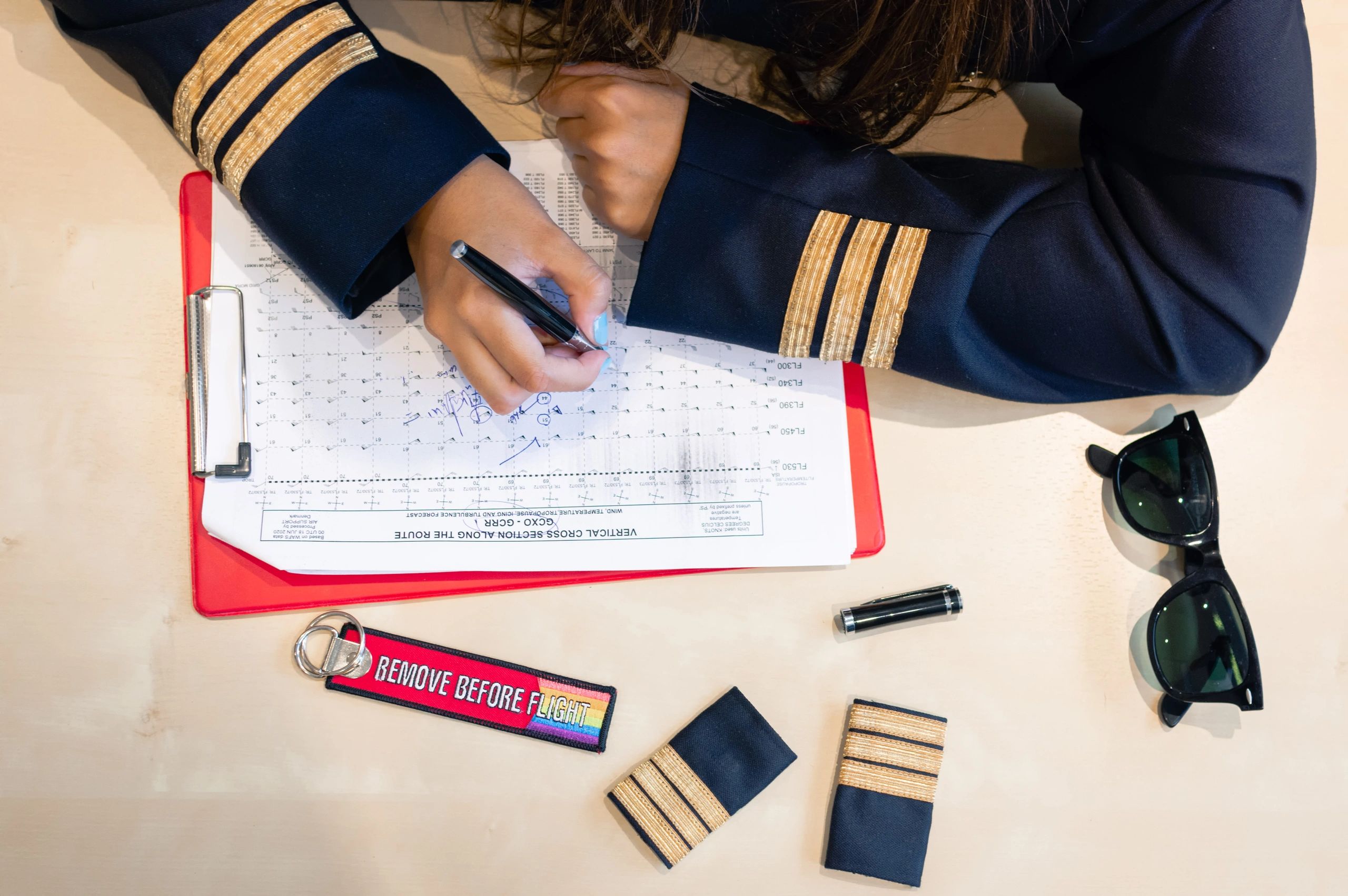 Student pilot preparing flight documentation and charts on a clipboard