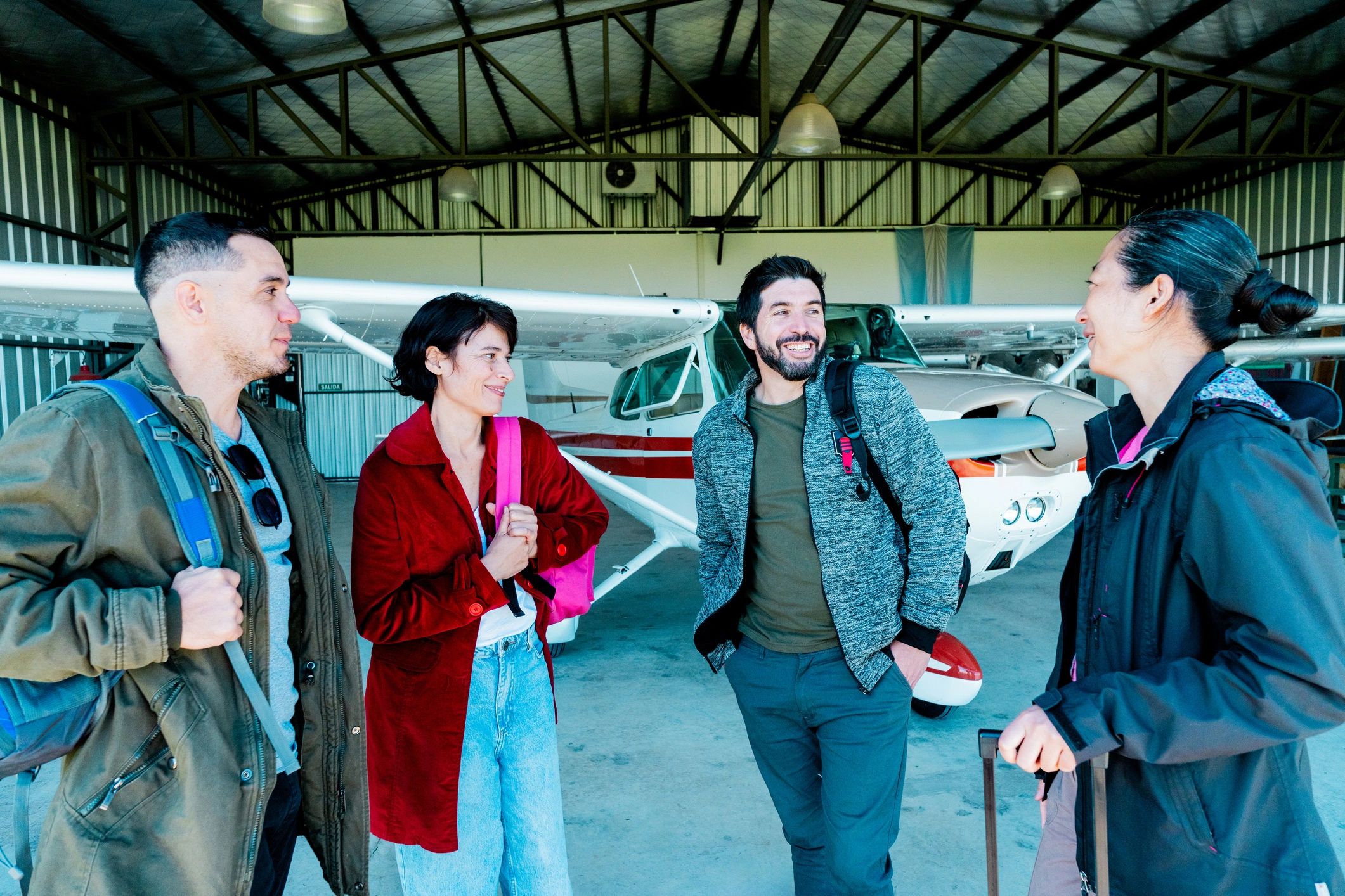 Two people talking in an airplane hangar