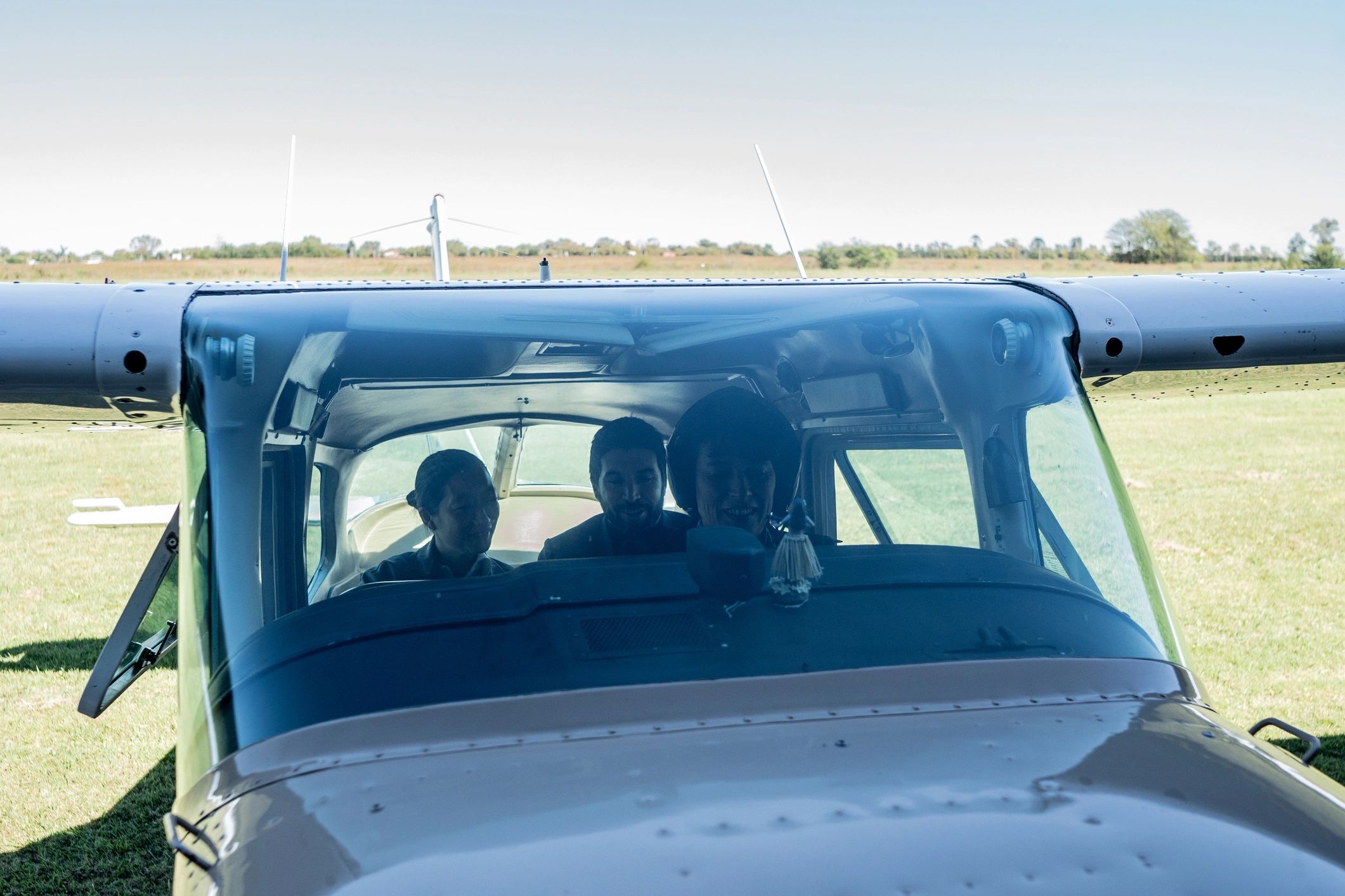 Pilot assisting passengers near a small aircraft