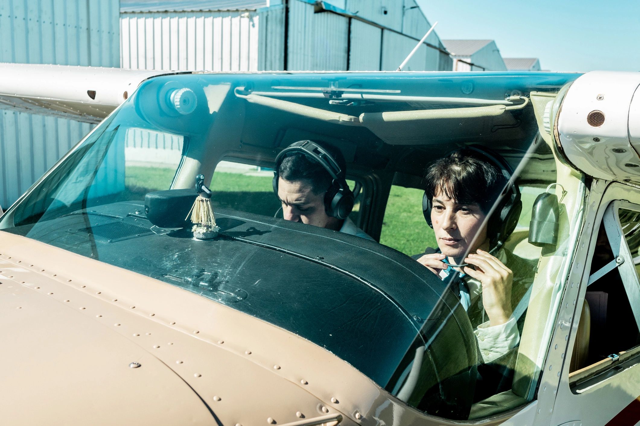 Flight instructor teaching a student in a cockpit