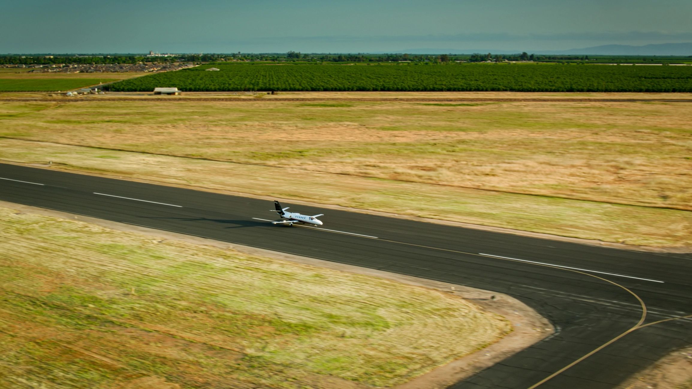 Small aircraft on approach to a runway at a general aviation airport